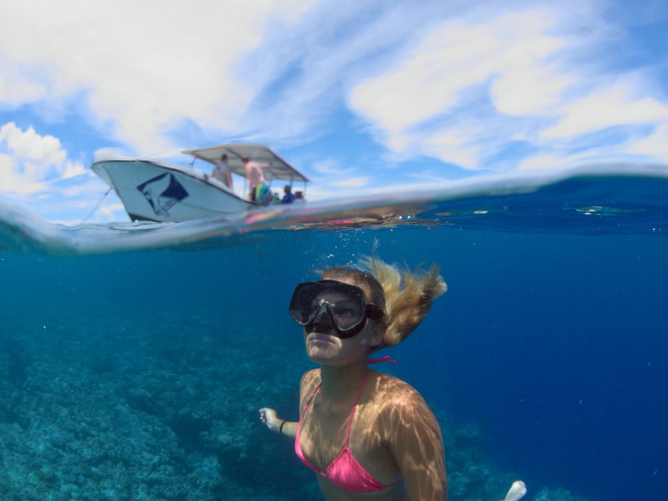 Freediver beneath the boat, Yap